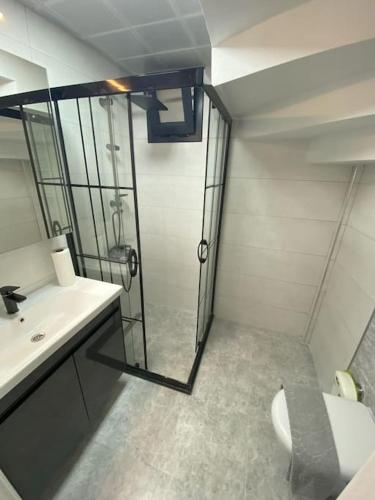a bathroom with a shower and a toilet and a sink at Villa Keyif in Seferihisar