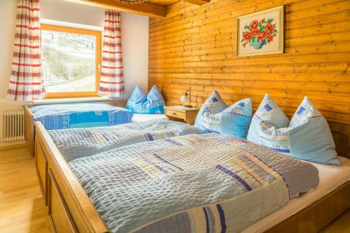 een slaapkamer met 2 bedden in een blokhut bij Lenzbauer in Lessach