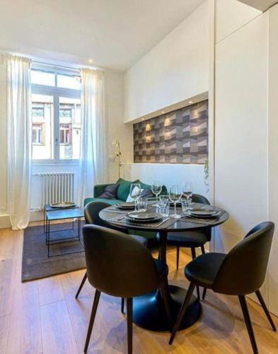 - un salon avec une table et des verres à vin dans l'établissement L'horizon, à Saint-Étienne