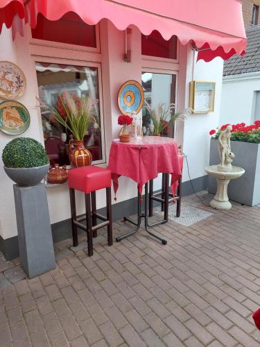 a table and chairs sitting outside of a restaurant at Tapas restaurante 1 in Viersen