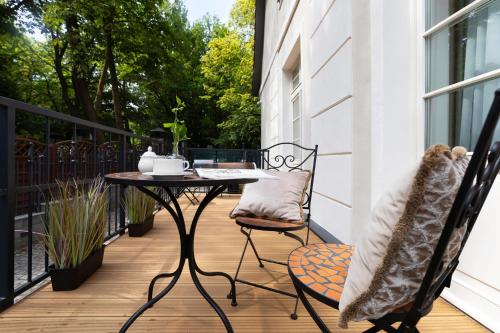 a patio with a table and chairs on a balcony at Willa Szwarc by Elite Apartments in Sopot