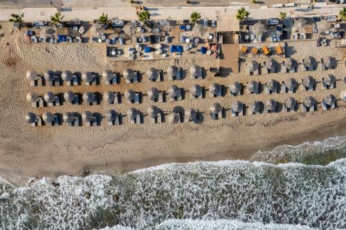 an aerial view of a beach with umbrellas at Galazio Beach Resort by Estia in Hersonissos