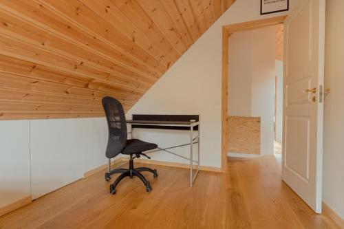 a desk in a room with a wooden ceiling at Nordic Serenity - Amazing Sea And Mountain View in Kirkjubøur