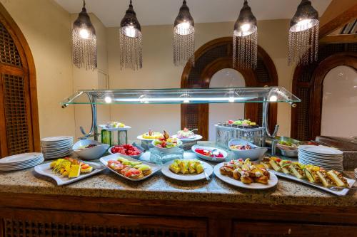 a buffet with many plates of food on a counter at Ghazala Gardens in Sharm El Sheikh
