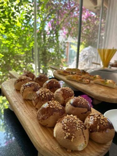 a tray of breads and pizzas on a table at Ambrosia Hotel Beach & Spa in Bitez