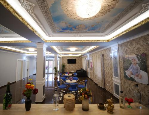 a living room with a coffered ceiling and a table at Hanna & Solei Hotel in Berat