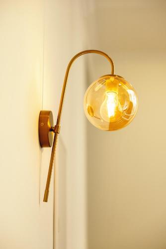 a light attached to a wall with a door at Boutique Hotel Manufactura in Tbilisi City
