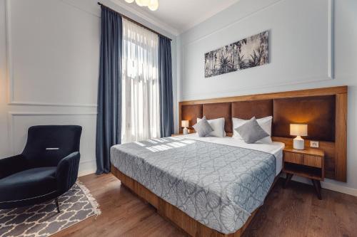 a hotel room with a bed and a chair at Boutique Hotel Manufactura in Tbilisi City