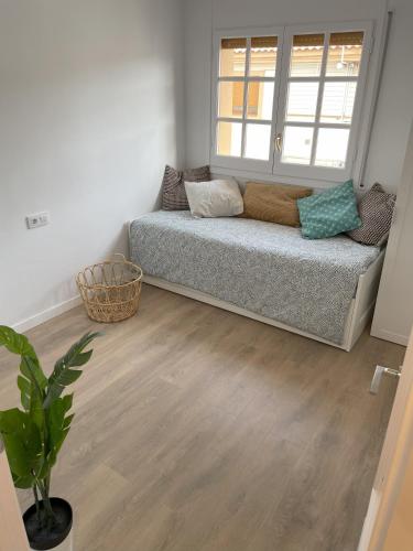 a room with a bed in a room with a window at Estudio al lado de la playa in Calafell