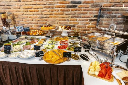 a buffet table with many different types of food at Boutique Hotel Manufactura in Tbilisi City