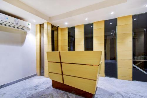 a closet with wooden dividers in a room at Super Collection O Snowfox in Kolkata