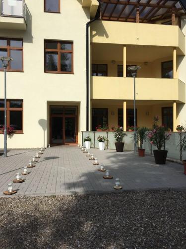 a building with a courtyard with candles in front of it at Penzión Probstner in Nová ľubovňa