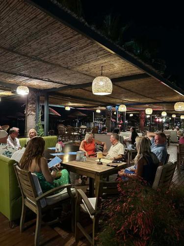 a group of people sitting at a table in a restaurant at Ambrosia Hotel Beach & Spa in Bitez