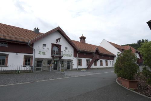 a row of white buildings with brown roofs at Hotel Gutshof Herborn in Herborn