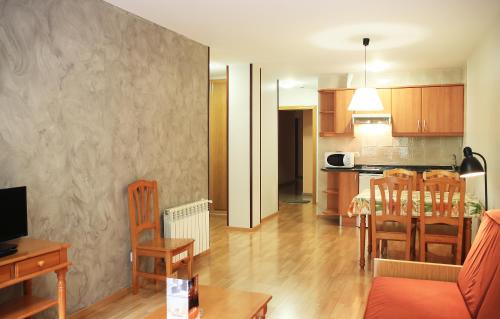 a living room with a kitchen and a dining room at Vista Arinsal Apartments in Arinsal