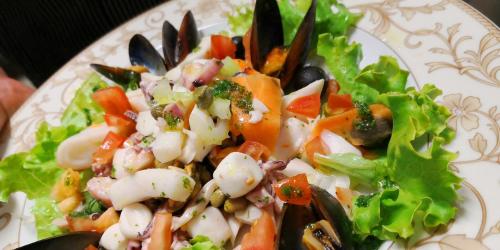 a plate of food with a salad on it at Millaenya Inn in Entratico