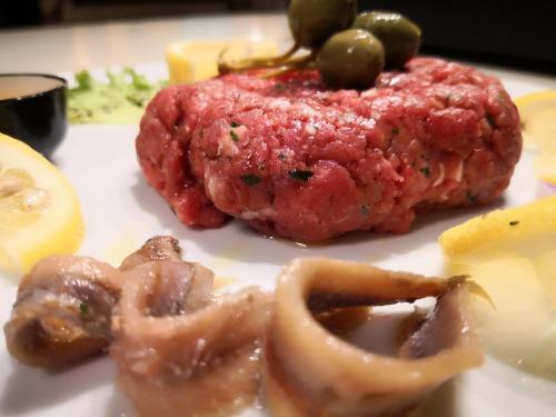a plate of food with meat and vegetables on it at Millaenya Inn in Entratico