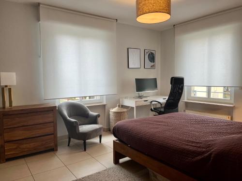 1 dormitorio con cama, escritorio y silla en Cozy and spacious 3 bedrooms with private garage & international TV, 