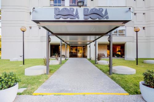 a walkway in front of a building with a sign at Oceana Suites BoraBora in Punta del Este