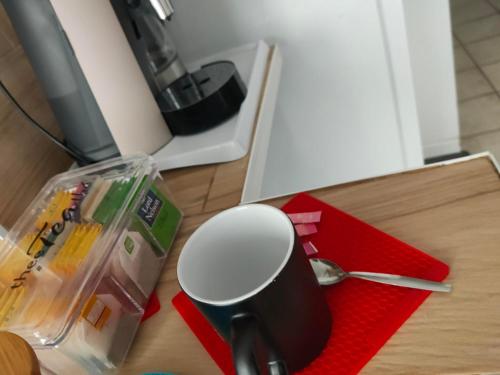 a coffee cup sitting on a red napkin on a table at Blanc de Tardy in Saint-Étienne