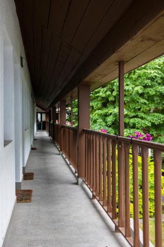 a balcony of a building with flowers on it at Pensiunea 7 Tei in Cisnadioara