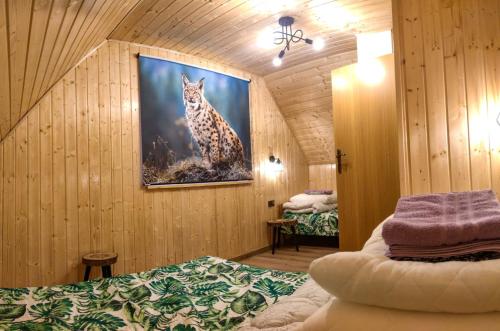 a room with a painting of a cheetah on the wall at Domki - Noclegi Pod Ostrym Działem in Ustrzyki Dolne