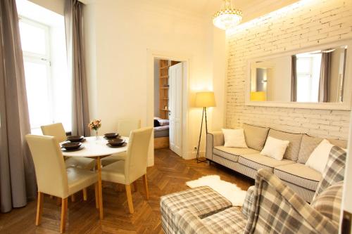 a living room with a couch and a table at City Center - Cozy And Bright - Dobra11 in Warsaw
