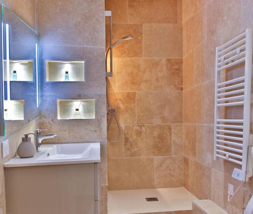 a bathroom with a sink and a shower at Cocon ardéchois in Aubenas