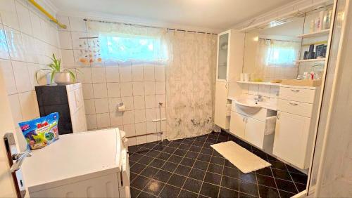 a small kitchen with a sink and a refrigerator at Dreamly Suites in Oslip