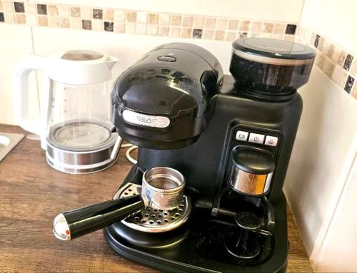 a coffee maker with a cup on a counter at Dreamly Suites in Oslip