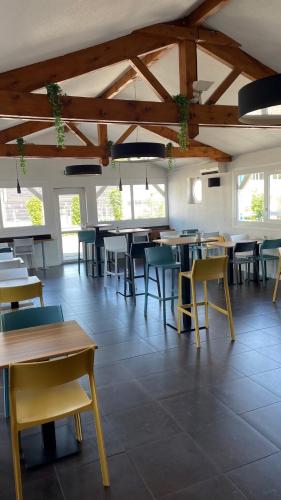a dining room with tables and chairs and windows at Ibis budget Chambéry Centre Ville in Chambéry