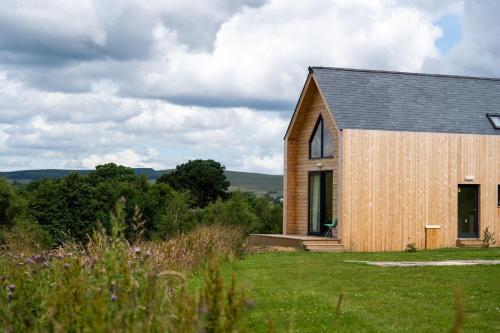 a wooden church with a gambrel roof at Tarset Tor - Bothy 2 in Hexham