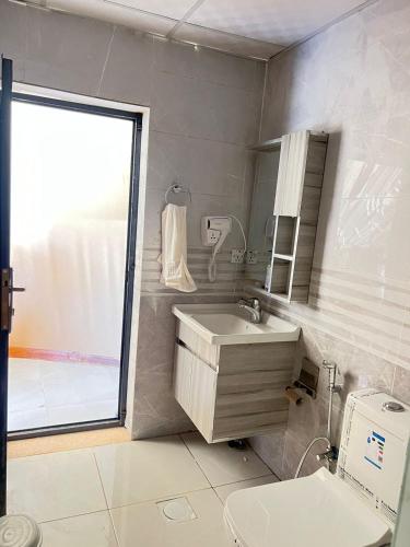 a bathroom with a sink and a toilet and a window at Wadi Rum stael Luxury Camp in Wadi Rum