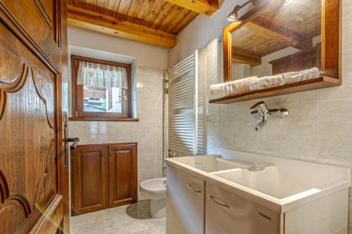 a bathroom with a sink and a toilet at Casa Beatrice in Courmayeur