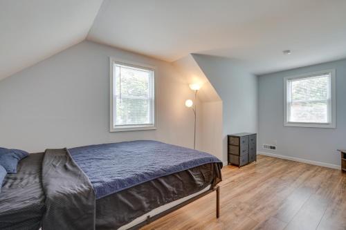 a bedroom with a bed and two windows at Middletown Township Home, Close to Beaches! in Leonardo