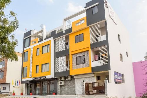 an image of a building with orange and white at Collection O 78427 Hotel Raj Regent in Somarda Kauasot