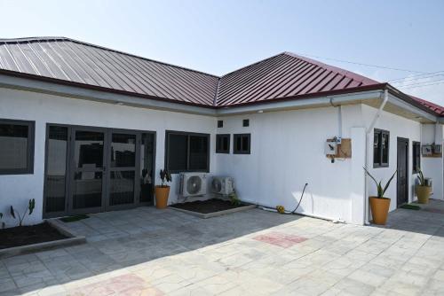 a white house with a metal roof at Lokko Serene in Accra