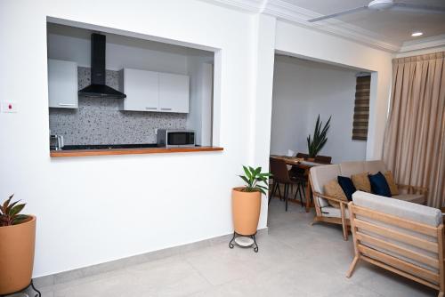 a kitchen and dining room with a table and chairs at Lokko Serene in Accra