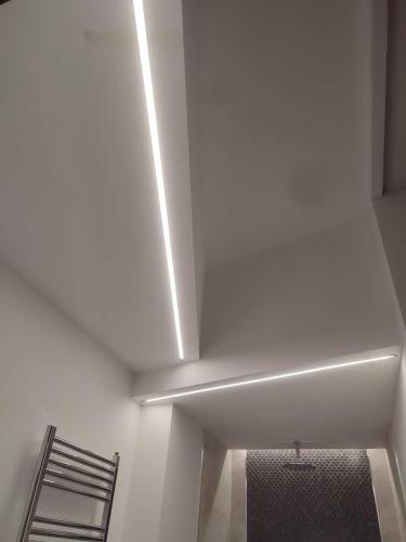 a white room with a white ceiling and a chair at Splendid Room Suites in Turin