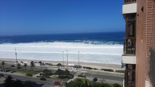 a view of the ocean from a building at Flat 2 suites com vista para o mar e lagoa. in Rio de Janeiro