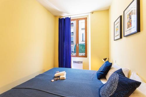 une chambre avec un lit bleu et une fenêtre dans l'établissement LE ST FRANCOIS AP4368 By Riviera Holiday Homes, à Nice