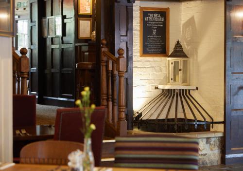 a dining room with a table and a sign on the wall at Chequers Inn by Greene King Inns in Maresfield