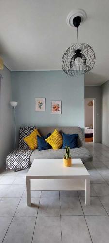 a living room with a couch and a table at Sea flight in Preveza