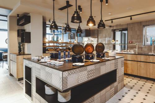 a restaurant with a large counter in a room at The Gast House Zell am See in Zell am See