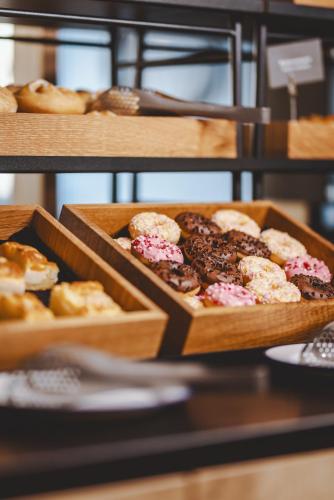 two boxes of donuts and other pastries on a shelf at The Gast House Zell am See in Zell am See