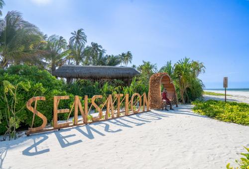 a sign that reads sanctuary on the beach at Sensations Eco-Chic Hotel in Pwani Mchangani Mdogo