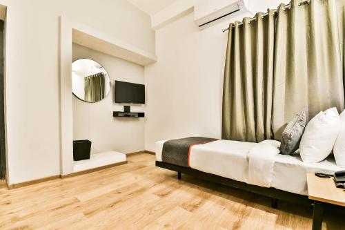 a bedroom with a bed and a mirror at Townhouse 182 Menka in Patna