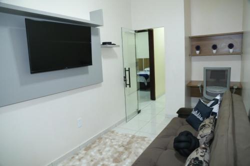 a living room with a couch and a flat screen tv at Apartamento excelente Marabá in Marabá