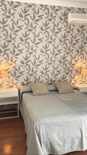 a bedroom with a black and white wallpaper with a bed at Las Américas - Mares in Torre del Mar