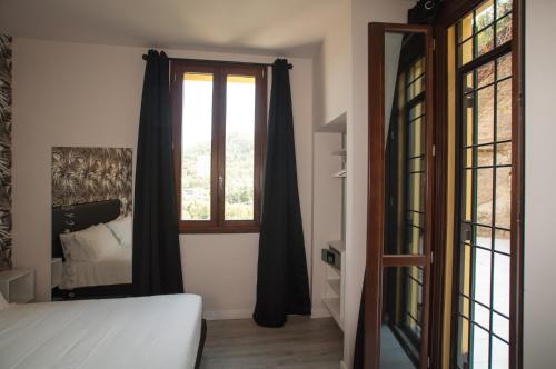 a bedroom with a bed and a window at Hotel Ca' di Gali in Sasso Marconi